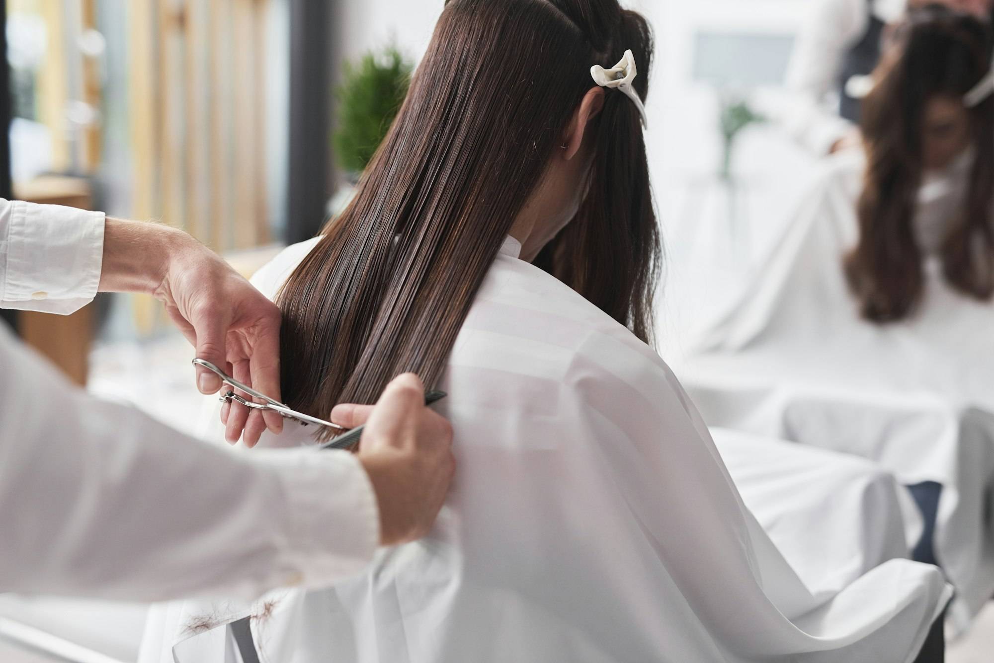 Close up of long hair cut by hairstylist