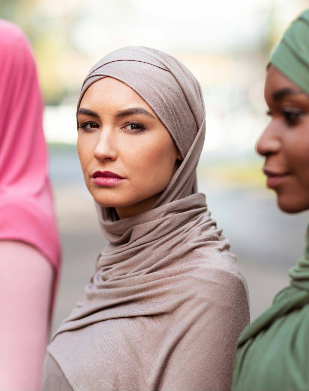 Group Portrait Of Three Multiracial Islamic Women Wearing Hijab Outside